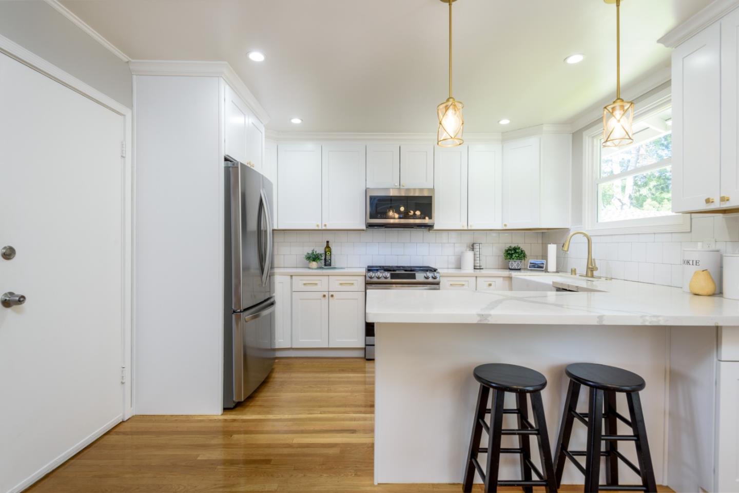 11 Meadow Court San Mateo, CA 94403 - Photo 7 of 31 a kitchen with stainless steel appliances granite countertop a refrigerator a sink dishwasher a stove and white cabinets with wooden floor