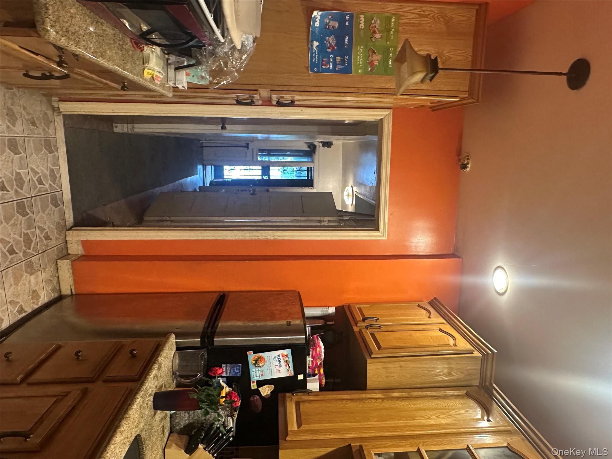 828 Lenox Road Brooklyn, NY 11203 - Photo 3 of 4 a kitchen with refrigerator a stove a sink cabinetry and a dining table