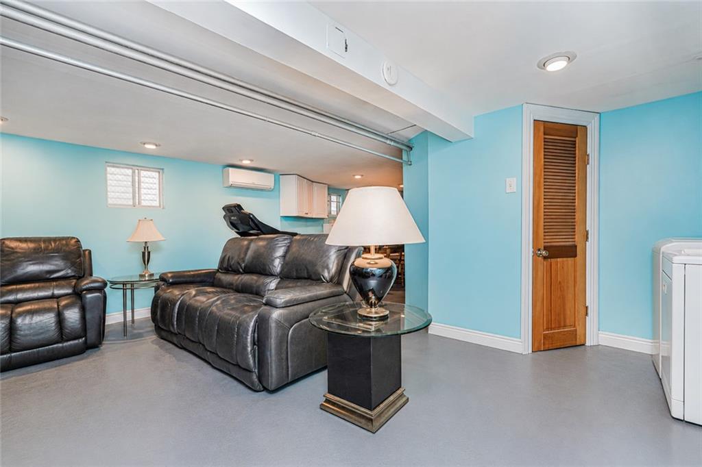 1352 Bay Ridge Parkway Brooklyn, NY 11228 - Photo 31 of 42 a living room with a couch and a dresser next to a window