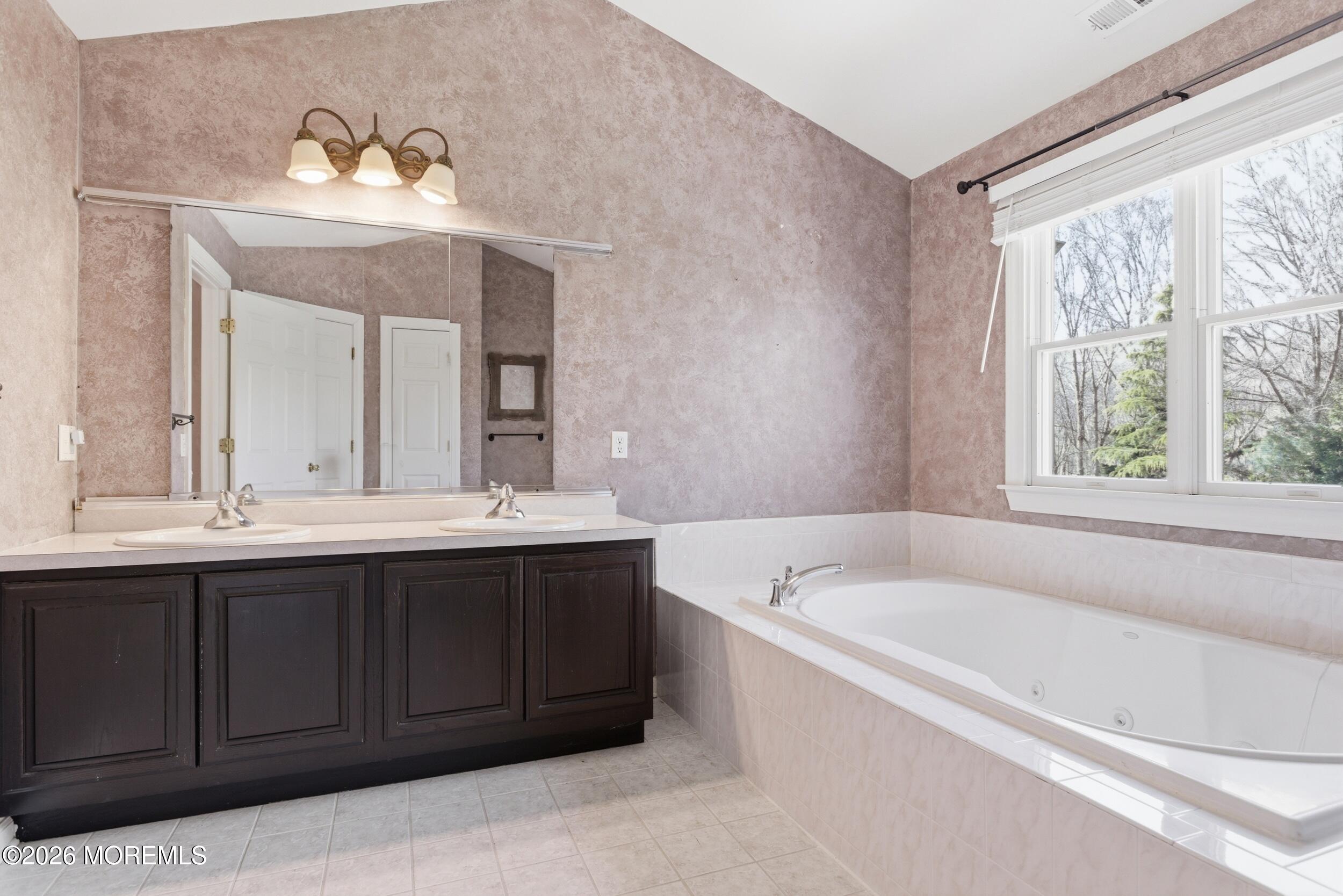 2 Mehar Court Jackson, NJ 08527 - Photo 17 of 47 a bathroom with a tub a sink and mirror