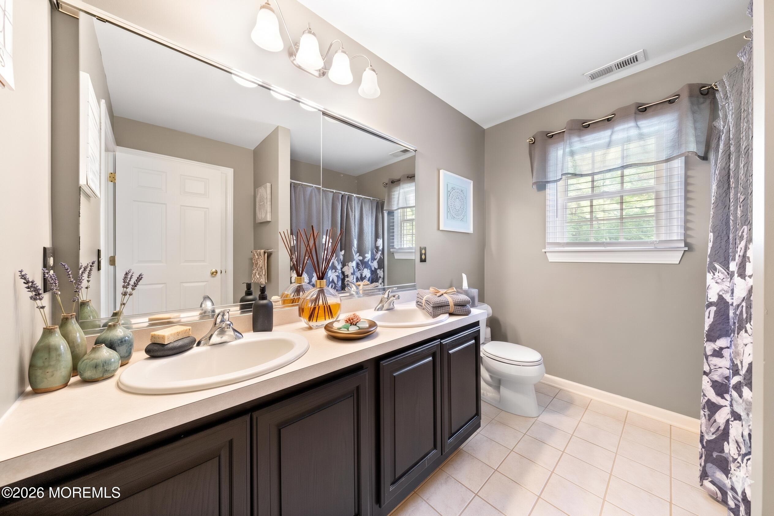 2 Mehar Court Jackson, NJ 08527 - Photo 24 of 47 a bathroom with a sink a toilet and mirror