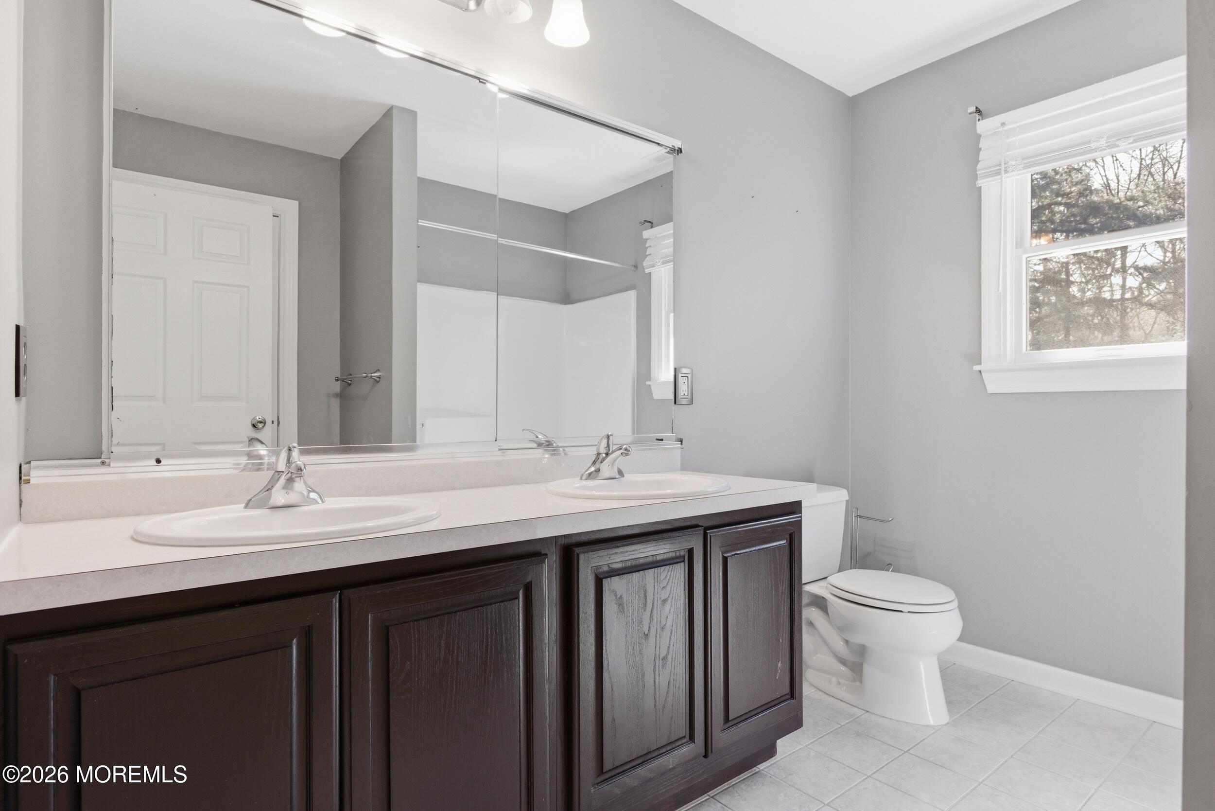 2 Mehar Court Jackson, NJ 08527 - Photo 26 of 47 a bathroom with a double vanity sink toilet and a mirror