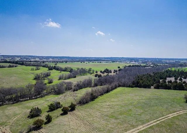 a view of a green field with an outdoor space