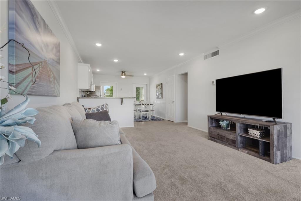 466 12th Avenue South, Unit 466 Naples, FL 34102 - Photo 18 of 34 a living room with furniture and a flat screen tv