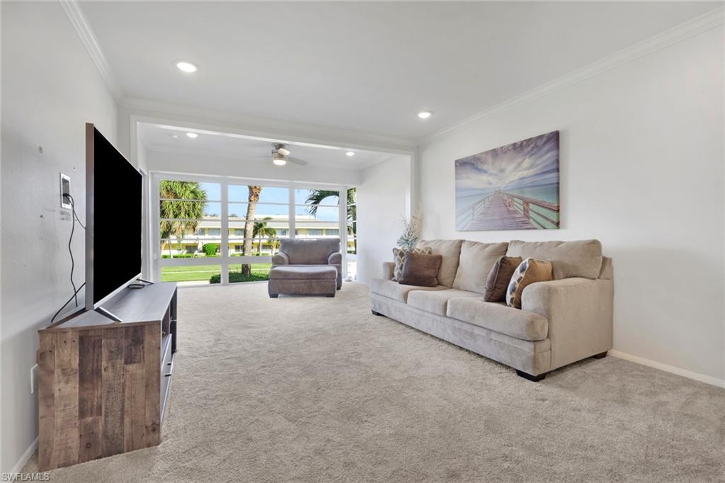 466 12th Avenue South, Unit 466 Naples, FL 34102 - Photo 19 of 34 a living room with furniture and a flat screen tv