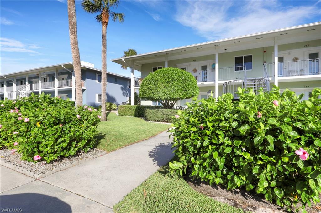 466 12th Avenue South, Unit 466 Naples, FL 34102 - Photo 2 of 34 a front view of a house with garden