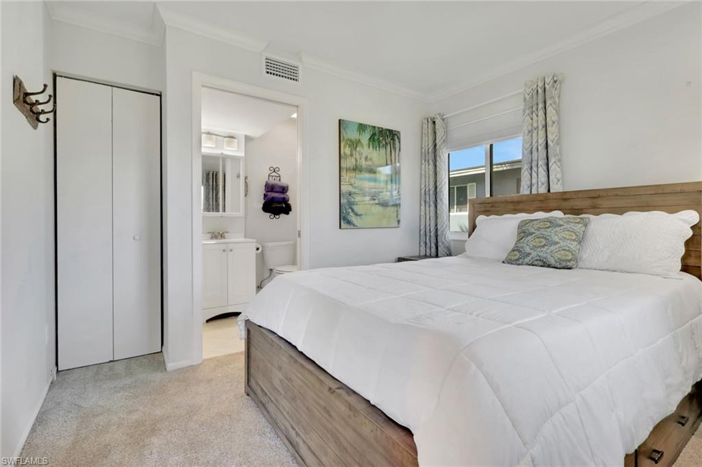 466 12th Avenue South, Unit 466 Naples, FL 34102 - Photo 24 of 34 a bedroom with a bed and a window