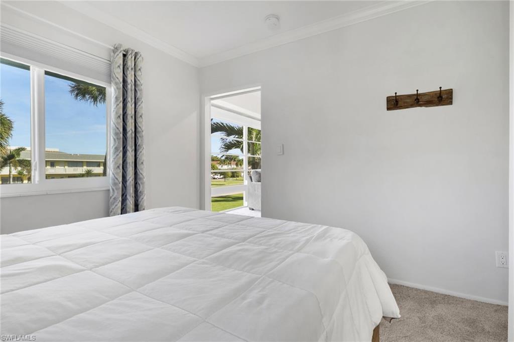 466 12th Avenue South, Unit 466 Naples, FL 34102 - Photo 25 of 34 a bedroom with a bed and a window
