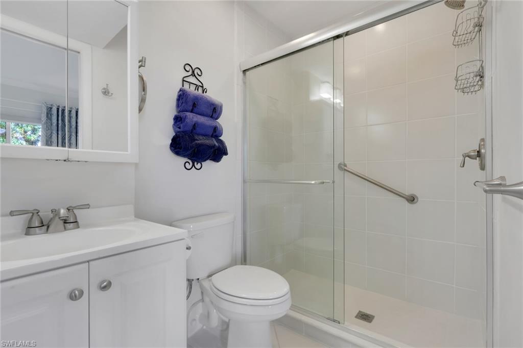 466 12th Avenue South, Unit 466 Naples, FL 34102 - Photo 26 of 34 a bathroom with a toilet sink and shower