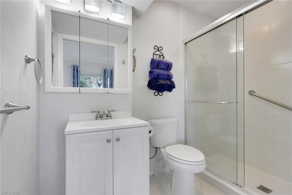 466 12th Avenue South, Unit 466 Naples, FL 34102 - Photo 27 of 34 a bathroom with a toilet sink and shower
