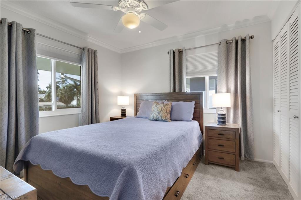 466 12th Avenue South, Unit 466 Naples, FL 34102 - Photo 29 of 34 a bedroom with a bed and a window
