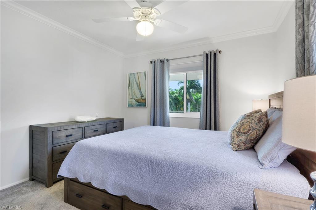466 12th Avenue South, Unit 466 Naples, FL 34102 - Photo 30 of 34 a bedroom with a large bed and a large window