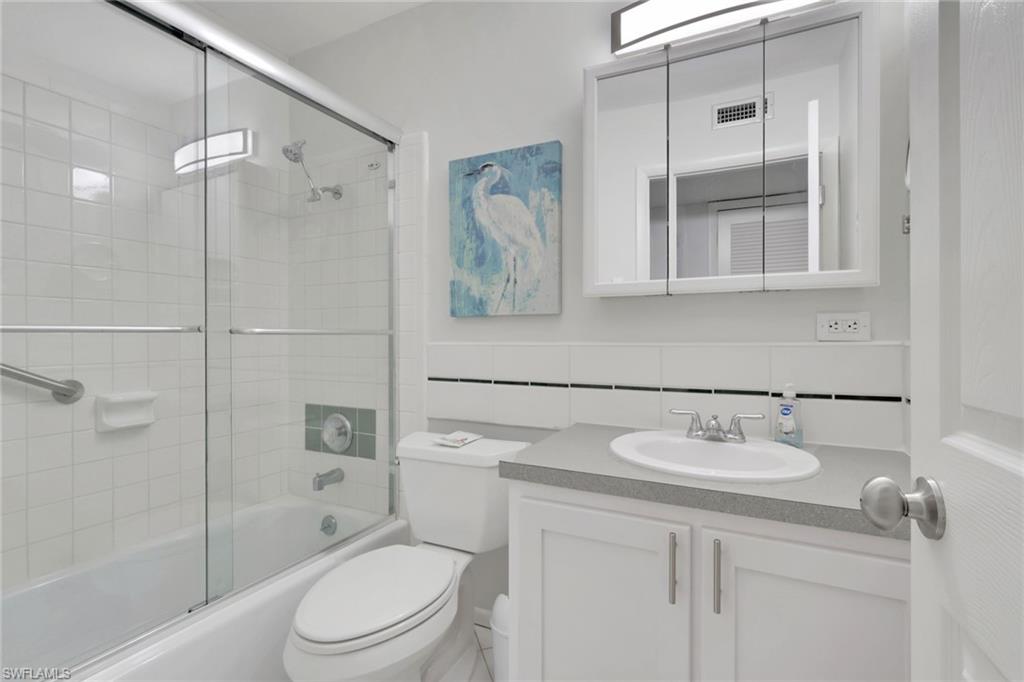 466 12th Avenue South, Unit 466 Naples, FL 34102 - Photo 31 of 34 a bathroom with a sink toilet and shower