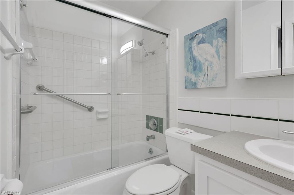 466 12th Avenue South, Unit 466 Naples, FL 34102 - Photo 32 of 34 a bathroom with a sink toilet and shower