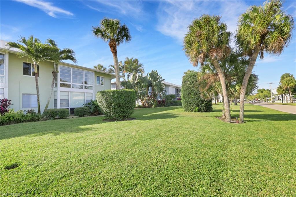 466 12th Avenue South, Unit 466 Naples, FL 34102 - Photo 33 of 34 a view of a house with a garden