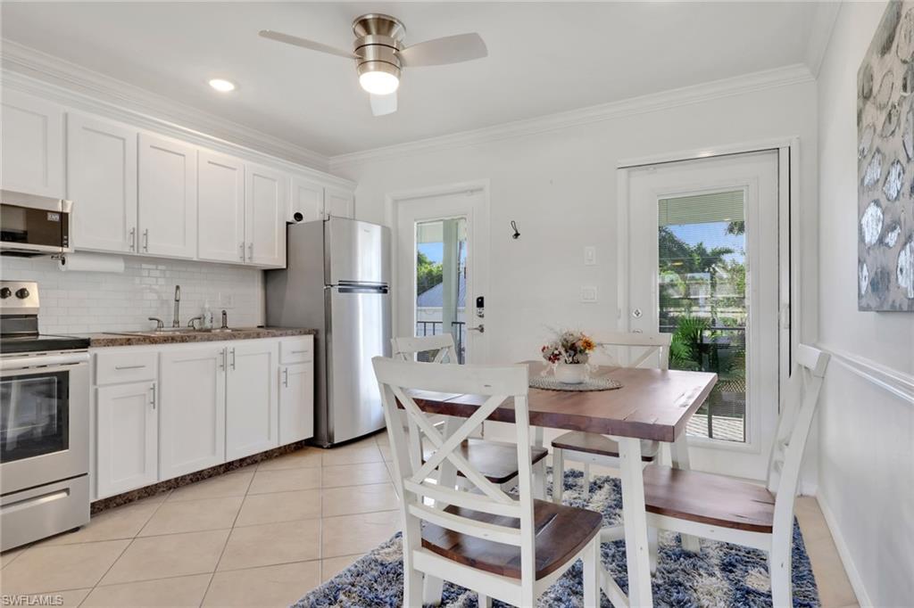466 12th Avenue South, Unit 466 Naples, FL 34102 - Photo 8 of 34 a kitchen with a dining table cabinets and appliances