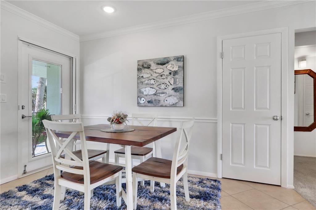 466 12th Avenue South, Unit 466 Naples, FL 34102 - Photo 9 of 34 a dining room with furniture and wooden floor