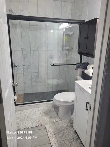 a bathroom with a toilet and a shower