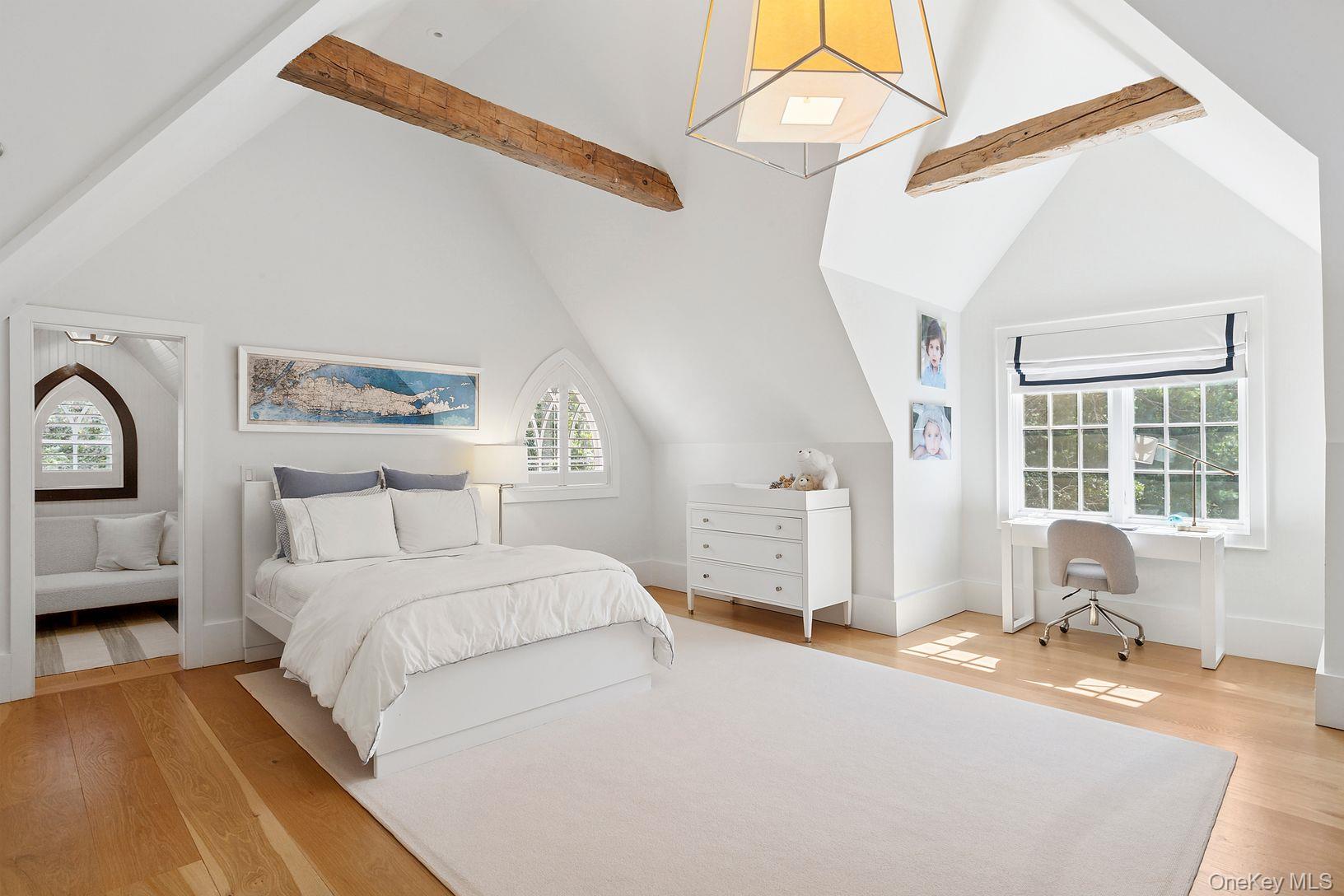 123 Abrahams Path East Hampton, NY 11937 - Photo 13 of 27 a spacious bedroom with a bed a table and chair