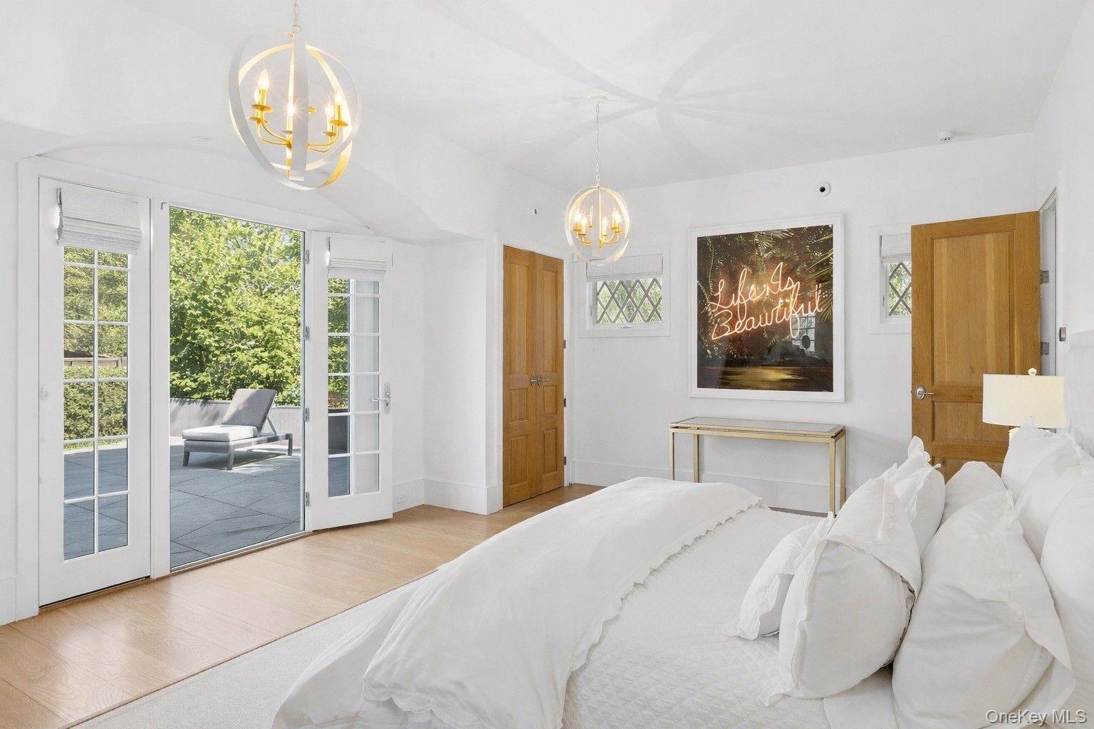 123 Abrahams Path East Hampton, NY 11937 - Photo 14 of 27 a bedroom with a bed and a large window