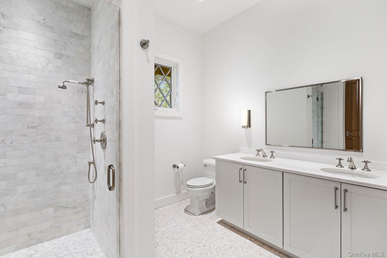 123 Abrahams Path East Hampton, NY 11937 - Photo 18 of 27 a bathroom with a toilet sink and mirror