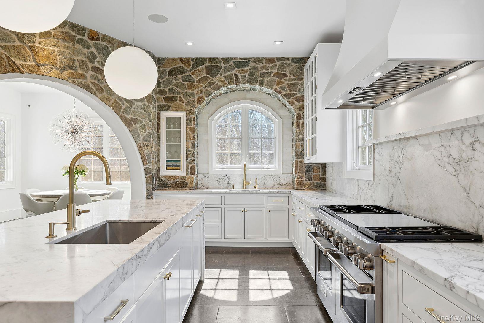 123 Abrahams Path East Hampton, NY 11937 - Photo 6 of 27 a kitchen with granite countertop a stove a sink dishwasher and white cabinets with wooden floor