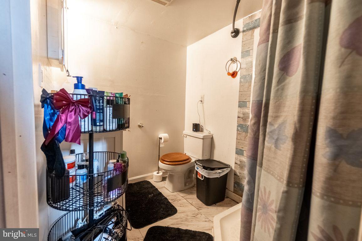 62 McKinley Avenue Hanover, PA 17331 - Photo 15 of 17 a bathroom with a toilet and a shower curtain