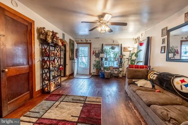 a living room with furniture and wooden floor