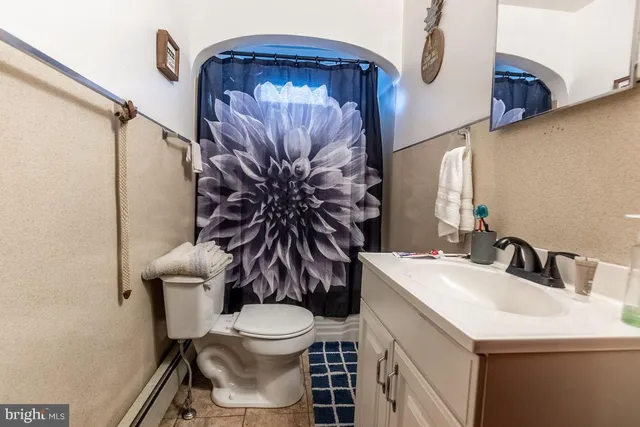 a bathroom with a toilet sink and mirror