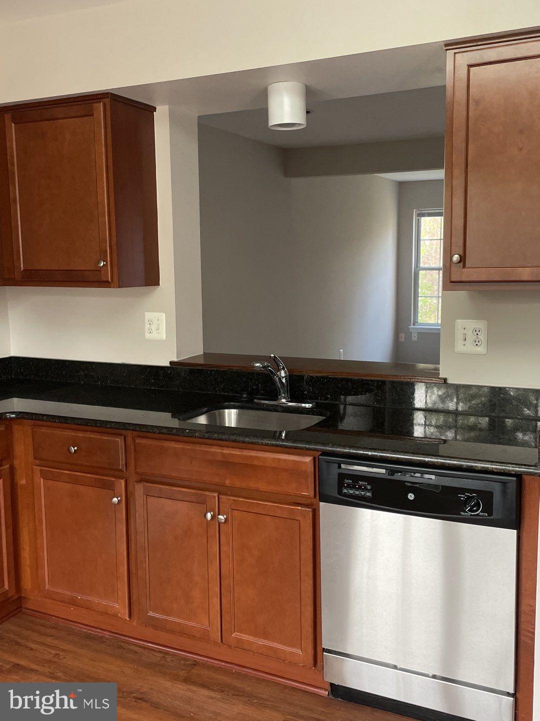 10366 College Square Columbia, MD 21044 - Photo 11 of 20 a kitchen with granite countertop cabinets and black appliances