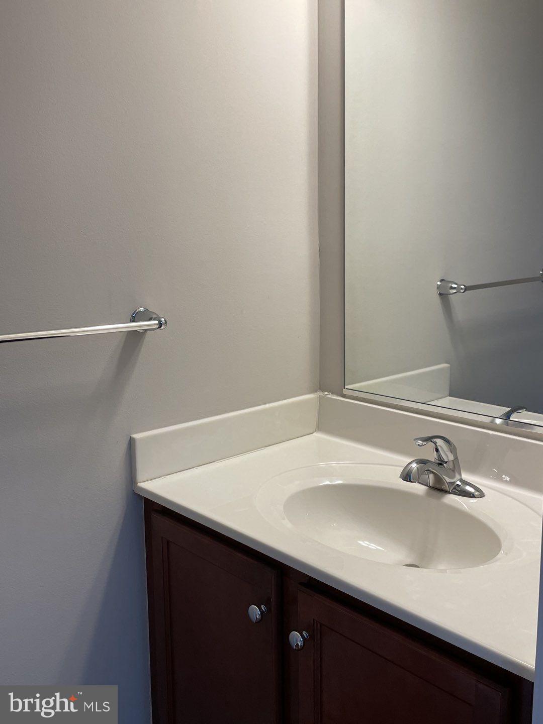 10366 College Square Columbia, MD 21044 - Photo 12 of 20 a bathroom with a sink and a mirror