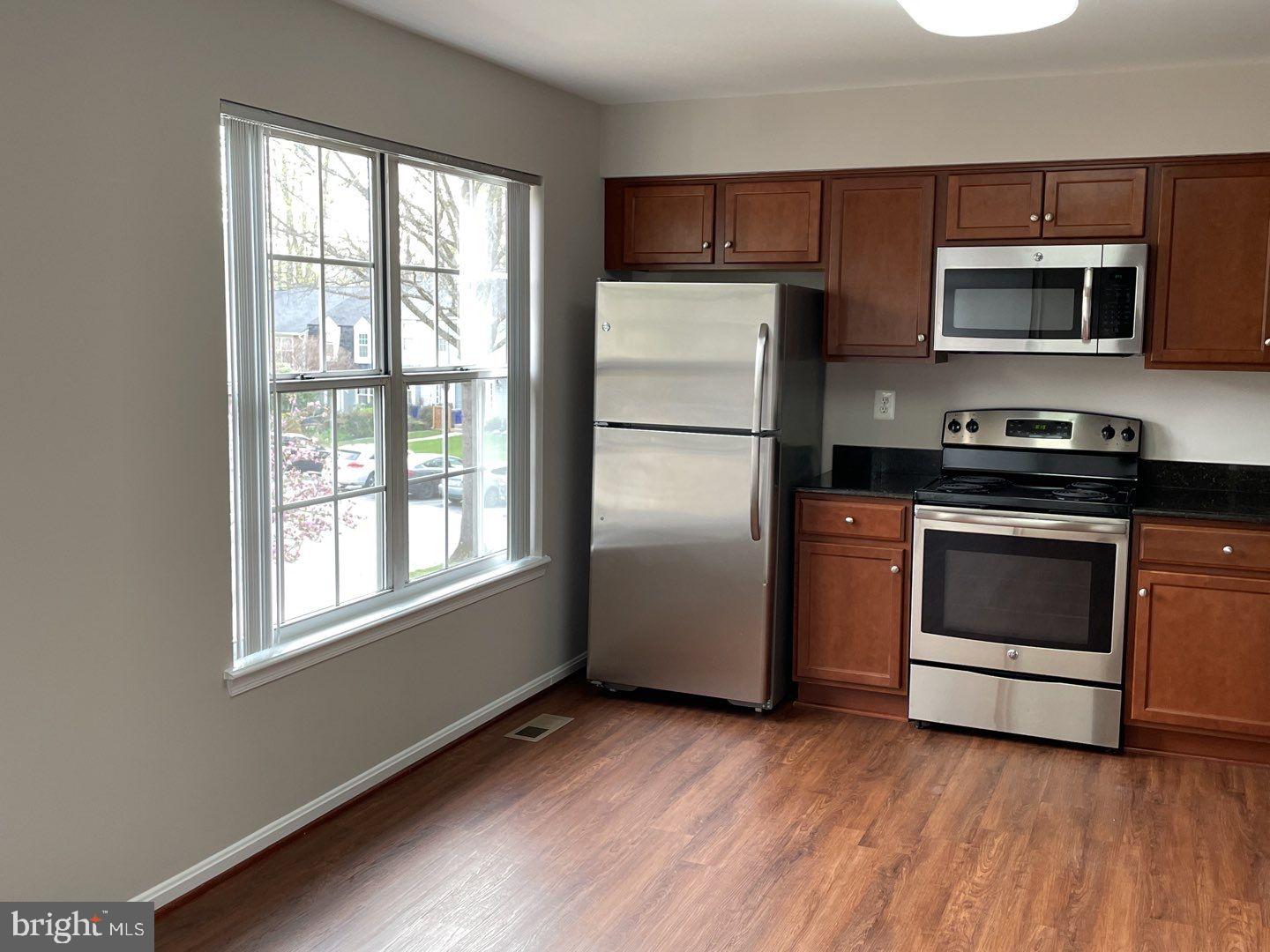 10366 College Square Columbia, MD 21044 - Photo 13 of 20 a kitchen with a refrigerator stove and microwave