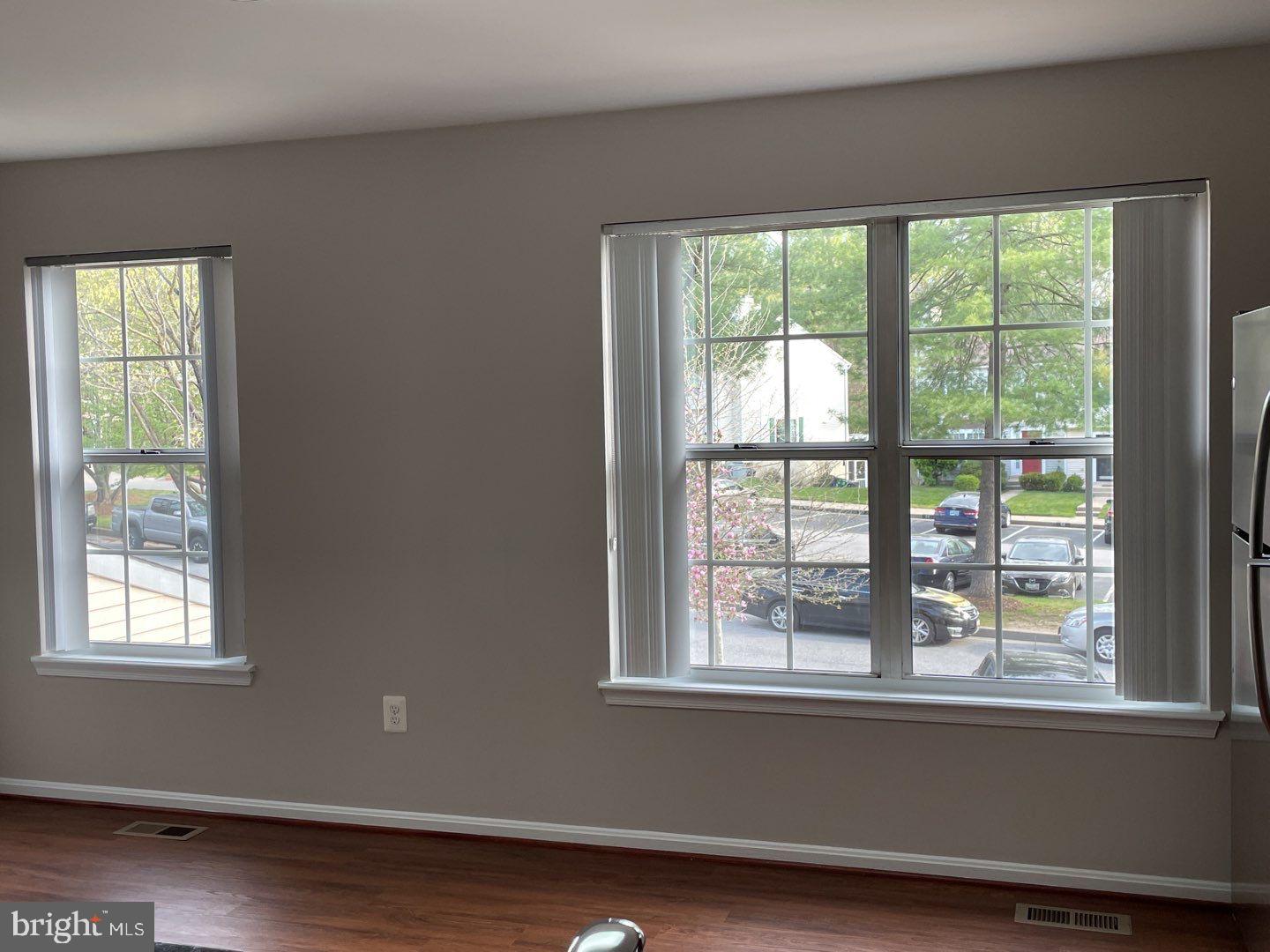 10366 College Square Columbia, MD 21044 - Photo 14 of 20 an empty room with wooden floor and a window