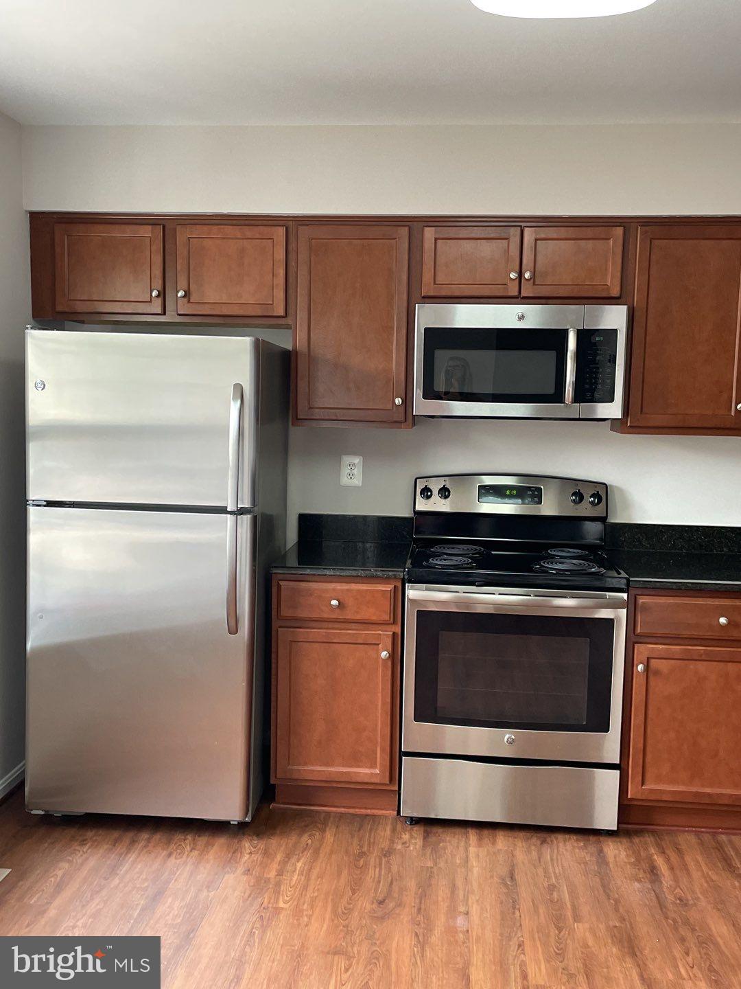 10366 College Square Columbia, MD 21044 - Photo 10 of 20 a kitchen with cabinets and stainless steel appliances