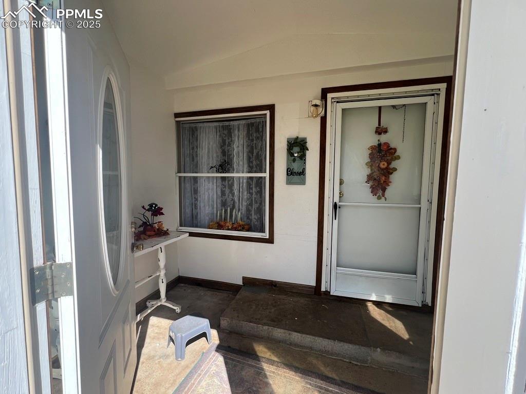 35875 Shear Road Yoder, CO 80864 - Photo 5 of 44 a view of a hallway with wooden floor and a living room