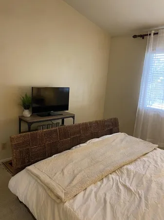 a view of a room with a bed and a window