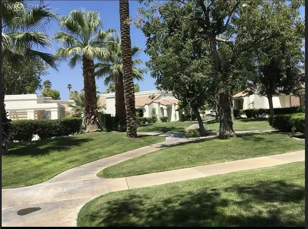 a view of a house with sitting area and swimming pool