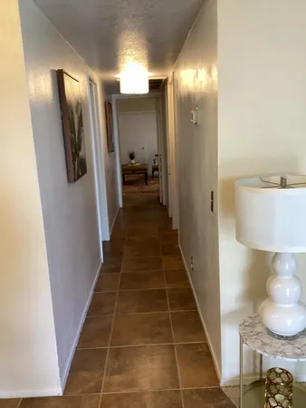 a bedroom with a bed and a lamp