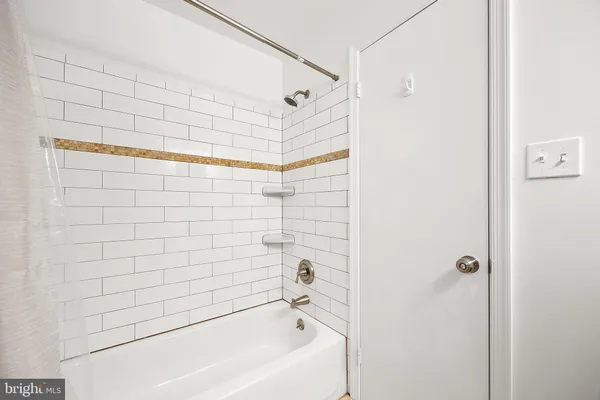 a bathroom with a bathtub and shower