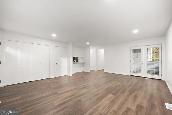 a view of an empty room with wooden floor