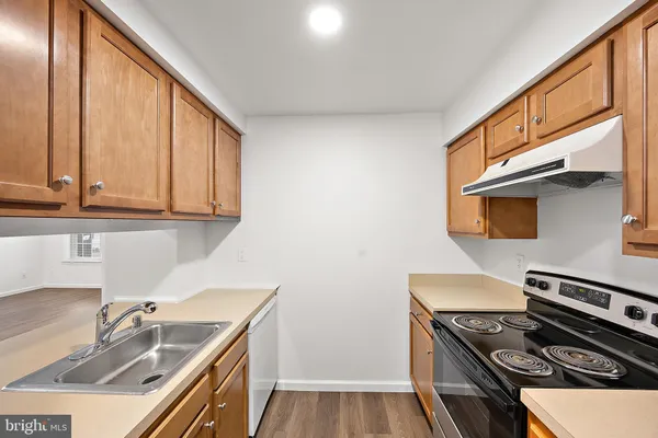 a kitchen that has a sink and a stove