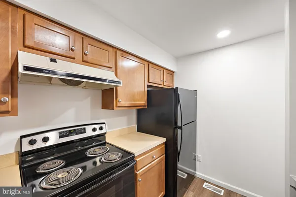 a kitchen with a stove and a refrigerator
