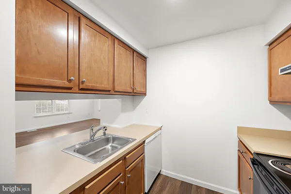 a kitchen with a sink cabinets and window