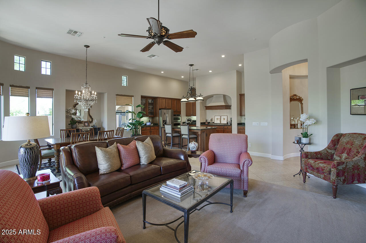 9190 East Hoverland Road Scottsdale, AZ 85255 - Photo 7 of 35 a living room with furniture kitchen view and a chandelier