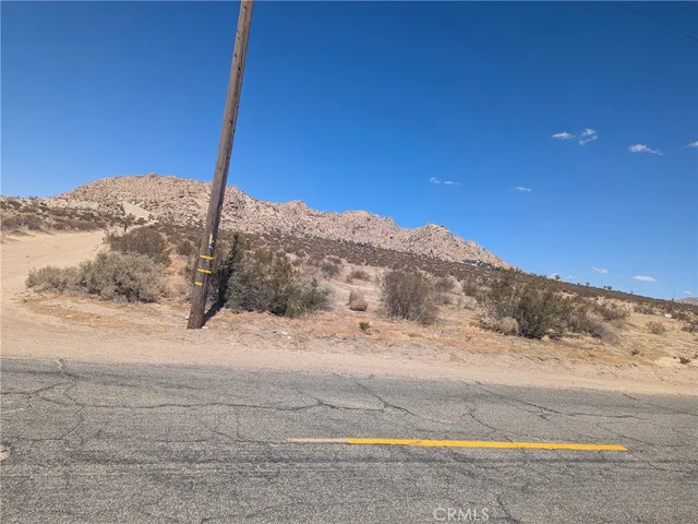 a view of a road with a snow in the background