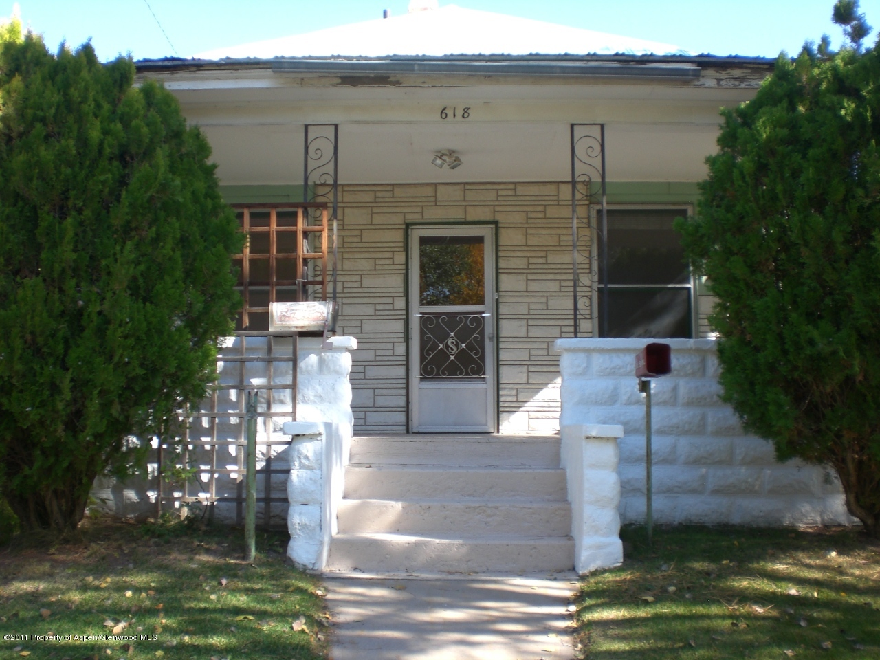 618 East Avenue Rifle, CO 81650 - Photo 2 of 30 a front view of a house with a yard