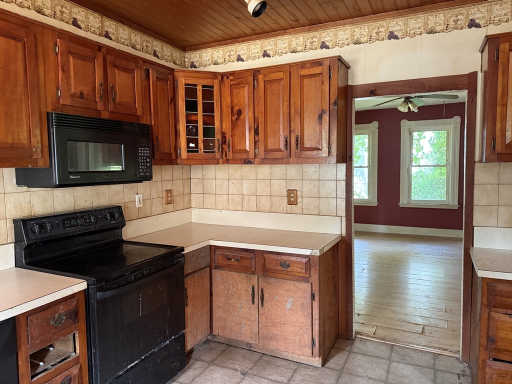 38 Elm Street Warren, MA 01083 - Photo 11 of 34 a kitchen with stainless steel appliances granite countertop a stove and a microwave