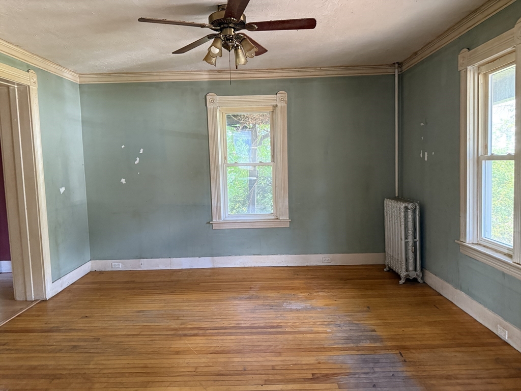 38 Elm Street Warren, MA 01083 - Photo 14 of 34 an empty room with wooden floor and windows