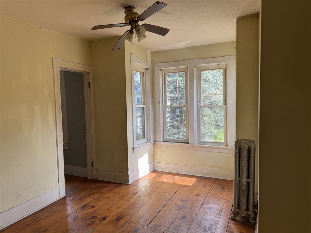 38 Elm Street Warren, MA 01083 - Photo 26 of 34 an empty room with wooden floor fan and windows