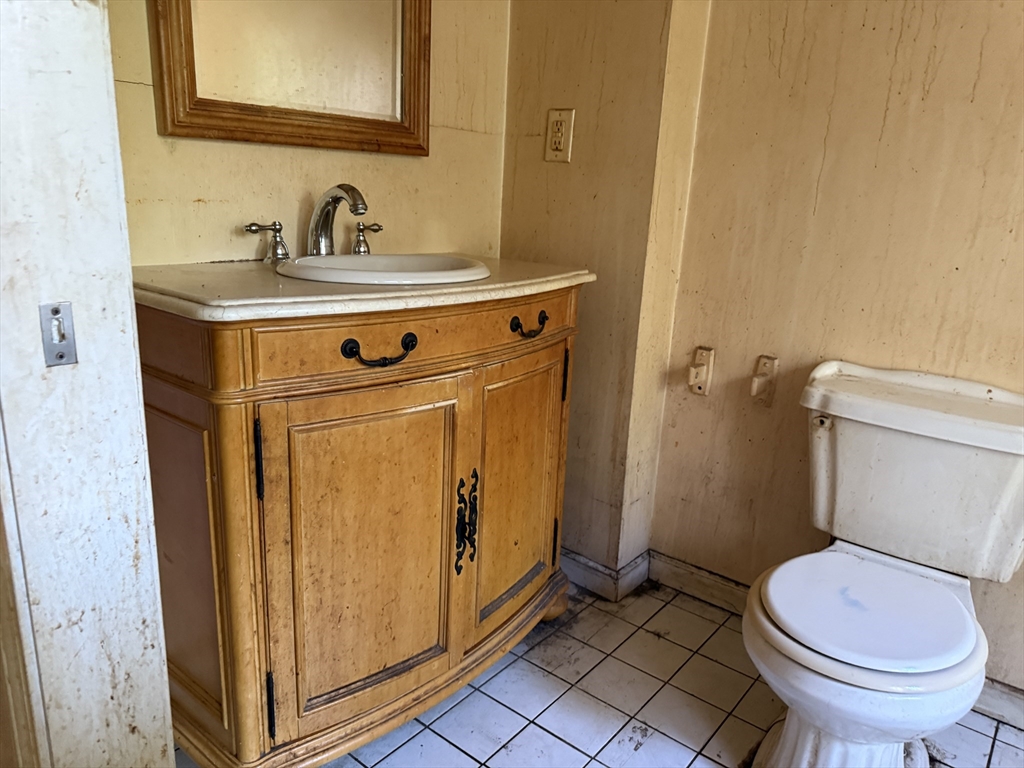 38 Elm Street Warren, MA 01083 - Photo 28 of 34 a bathroom with a sink a toilet and a mirror